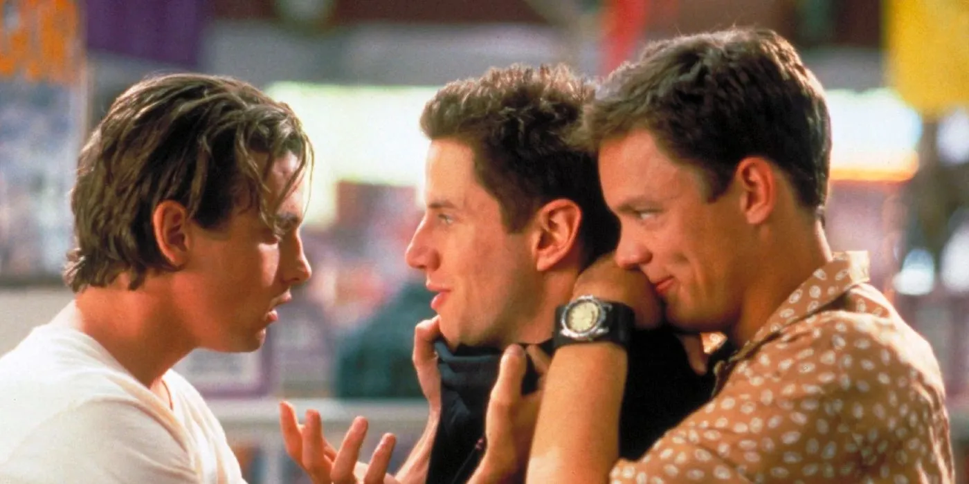 A scene featuring Matthew Lillard in a tense confrontation with two other young men in a high school setting. Lillard, wearing a black jacket, is being held by one man while the other looks at him intensely. The image captures the dramatic and rebellious energy of late 1990s teen cinema.