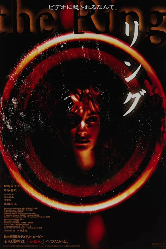 Ringu (1998) Japanese movie poster featuring a haunting red-tinted face emerging from darkness, surrounded by a glowing, eerie red ring. The stylized Japanese text enhances the unsettling atmosphere, hinting at the cursed videotape's supernatural terror. A chilling tagline at the top teases the film's deadly premise.