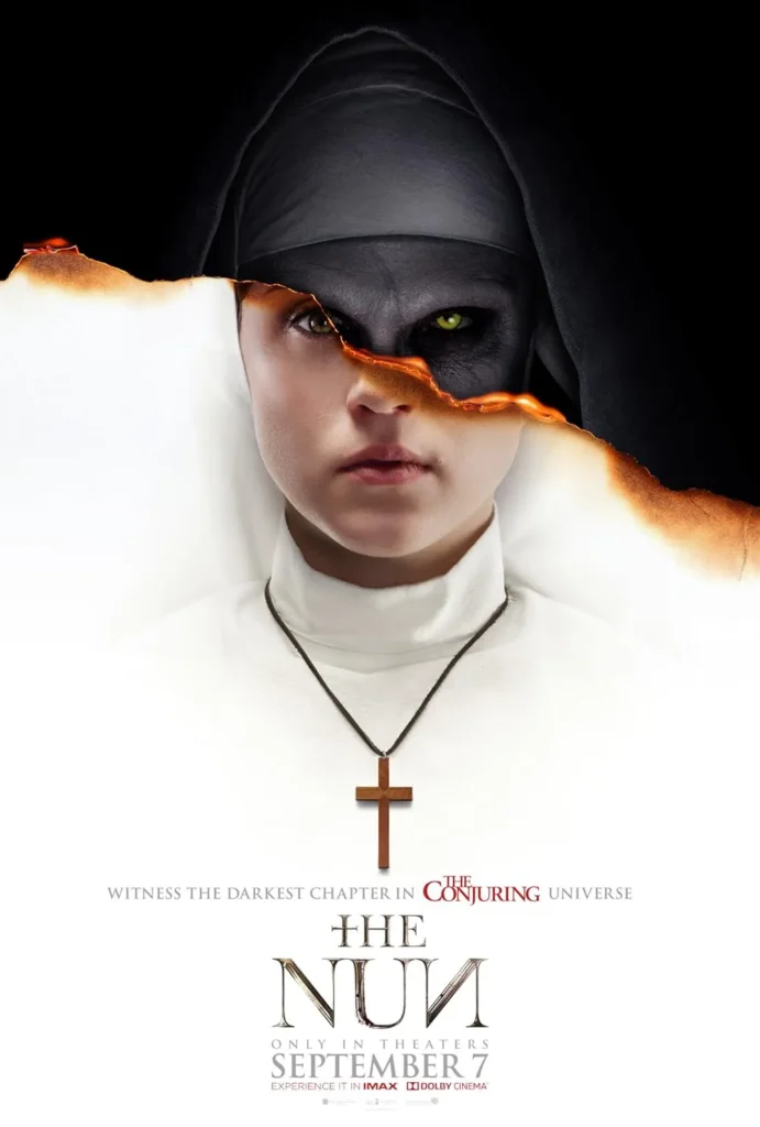 The Nun (2018) Movie Poster: A striking promotional poster for The Nun, part of The Conjuring universe. The image features a young nun in a white habit, her solemn face partially torn away to reveal the sinister visage of Valak, the demonic nun with glowing yellow eyes. The burnt edges of the tear create a haunting effect, blending purity and horror. Below, a wooden cross hangs from her neck, symbolizing the battle between good and evil. The tagline reads, "Witness the darkest chapter in The Conjuring Universe.