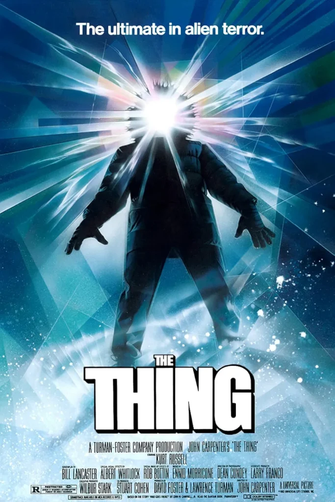 The Thing movie poster featuring a silhouetted figure in heavy winter clothing standing in a snowy landscape, with a blinding white light exploding from its face, sending jagged beams in all directions. The tagline above reads, 'The ultimate in alien terror,' emphasizing the film's sci-fi horror theme.