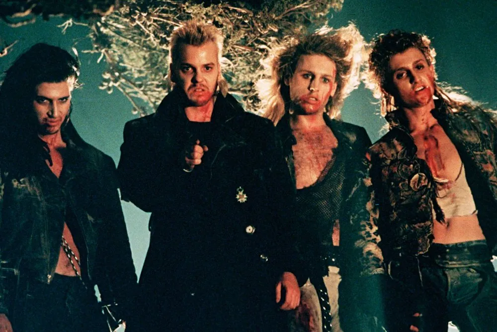The vampire gang from The Lost Boys (1987), led by Kiefer Sutherland’s David, standing together at night with menacing expressions.